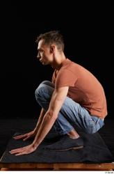 Alessandro Katz  black shoes blue jeans brown t shirt casual dressed kneeling whole body  jpg